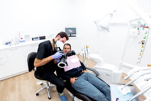 Clinica Dental Arcade logo